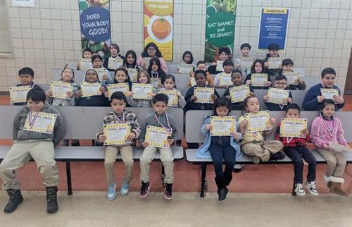  Student of the month students holding certificates 